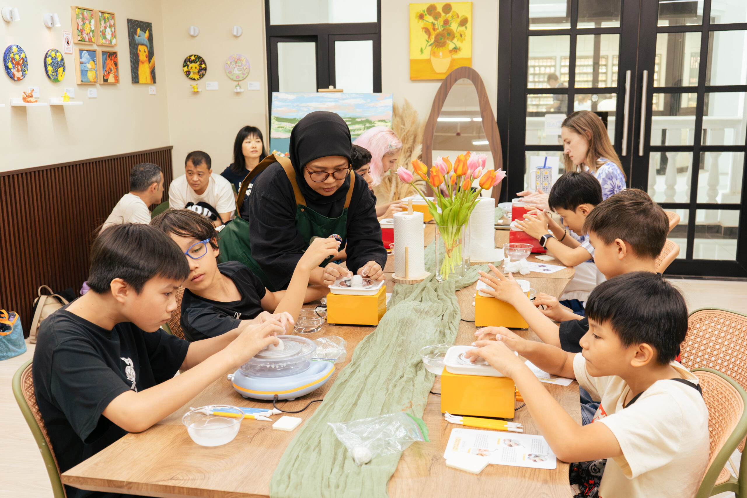 A real group enjoying a pottery workshop at ArtRoots Studio