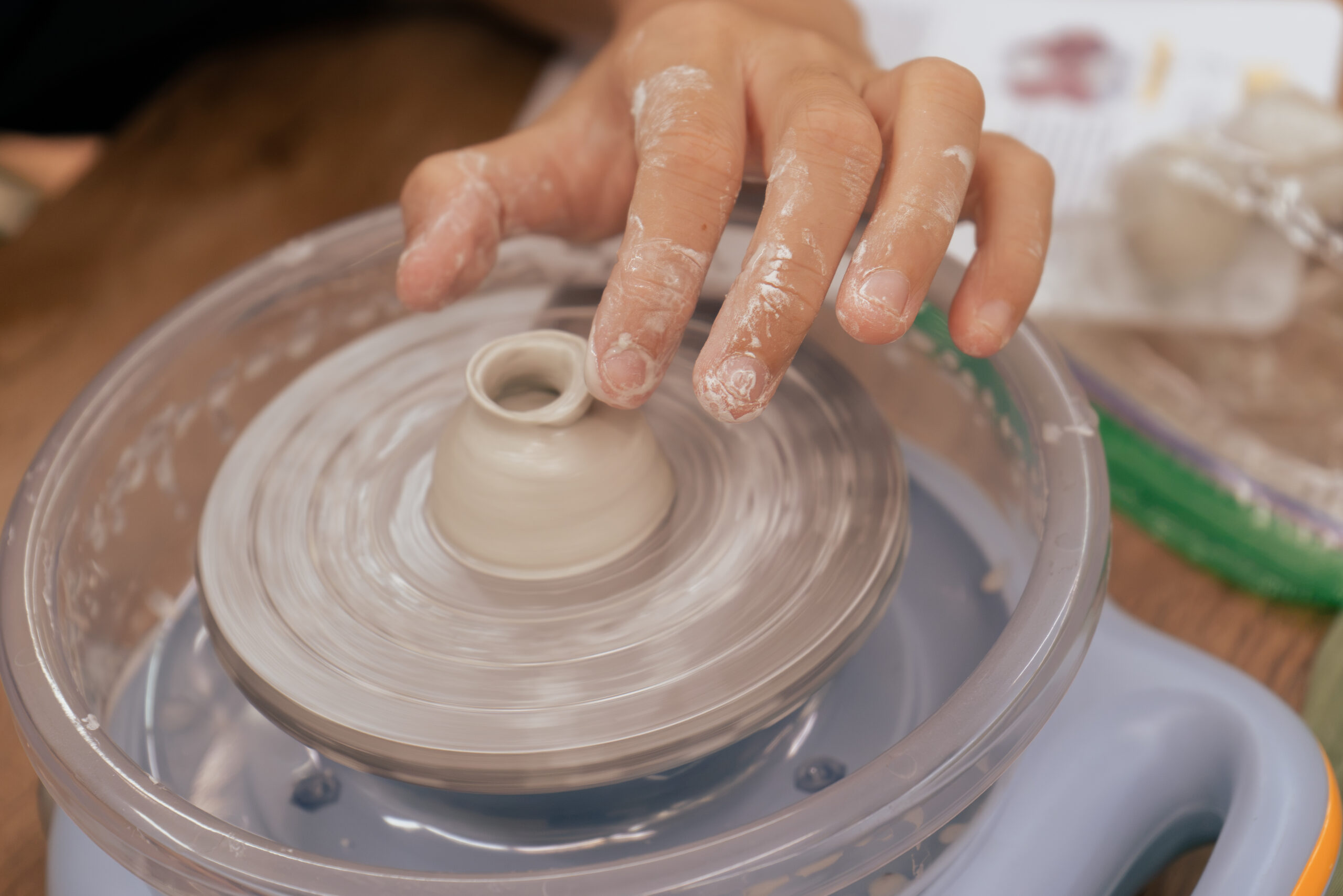Hands shaping a miniature pot at an ArtRoots Mini Pottery workshop